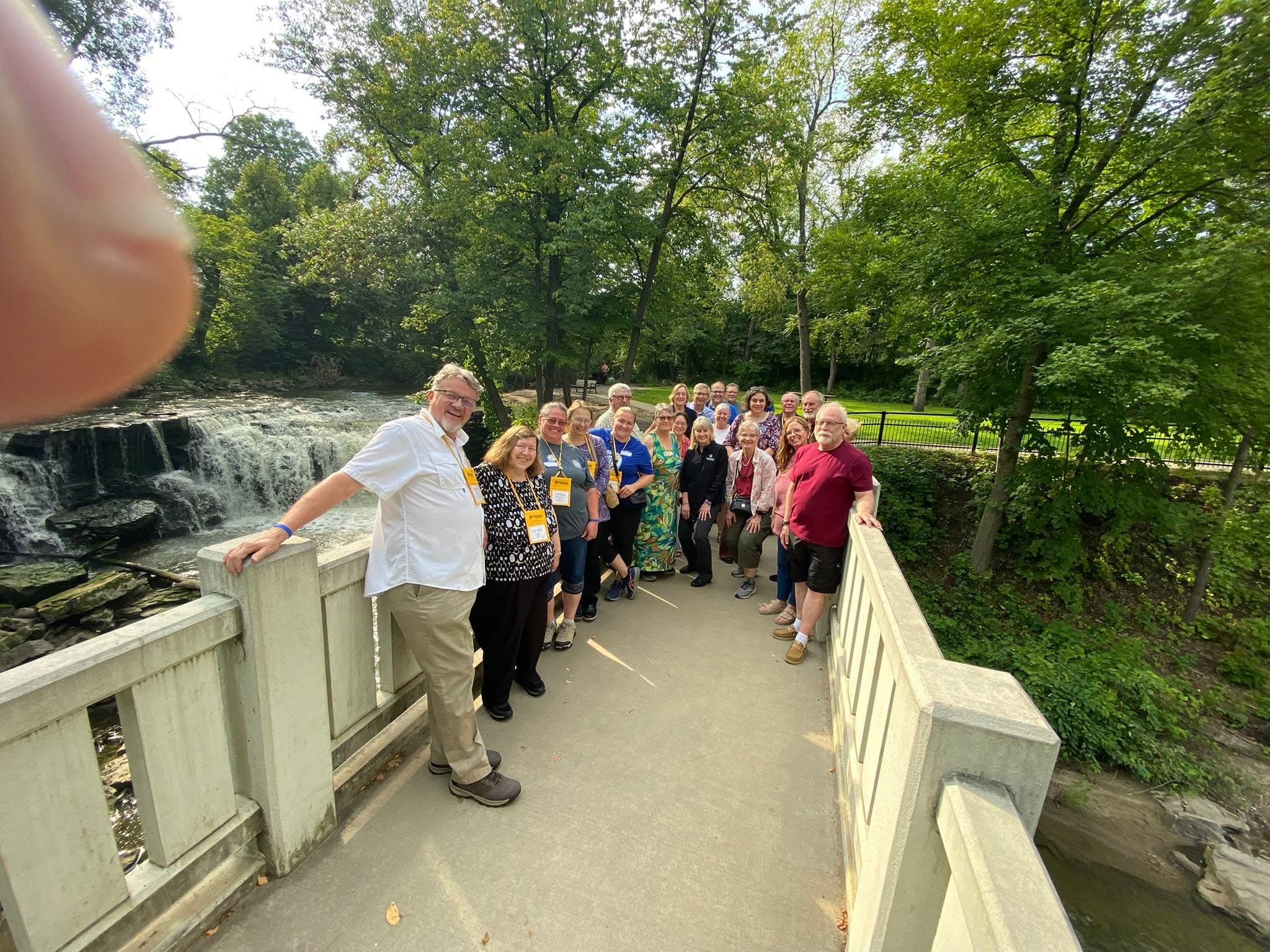 Club members gathered on a bridge overlooking the falls